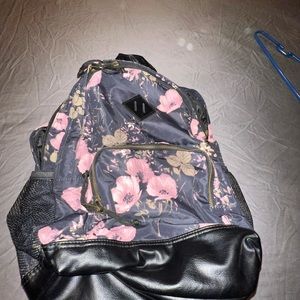Black floral back pack. It has a lot of pockets and small compartments.